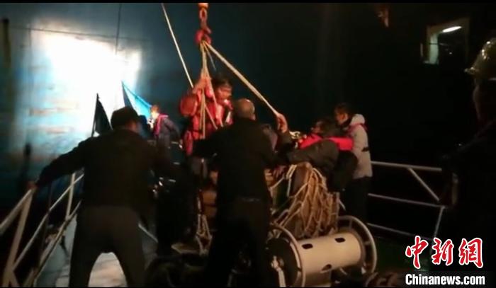 1月19日，10名获救缅甸船员被“SITC SURABAYA”轮救起并通过吊篮转移到漳州海事局“海巡0801”轮上。(视频截图) 张丽君 摄