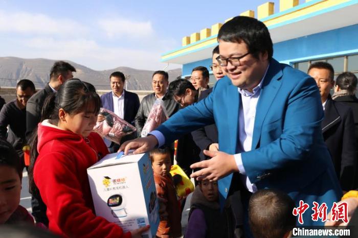 甘肃省青年企业家商会会长、天庆集团总经理韩泽华作为代表赴贫困地区东乡县，参加他们捐建的幼儿园开园仪式，并为孩子们赠送AI教育机器人。　钟欣 摄